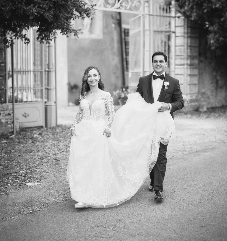 the extraordinaire groom carrying wedding dress