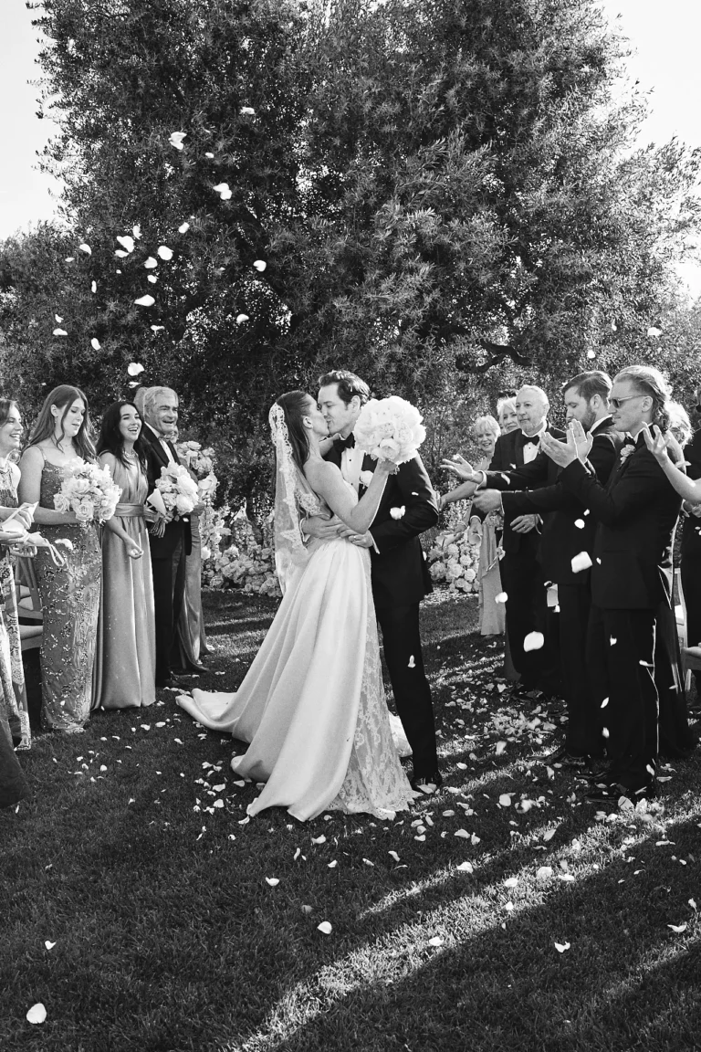 the extraordinaire puglia residenza la pettolecchia black and white photo of couple kissing during petal toss