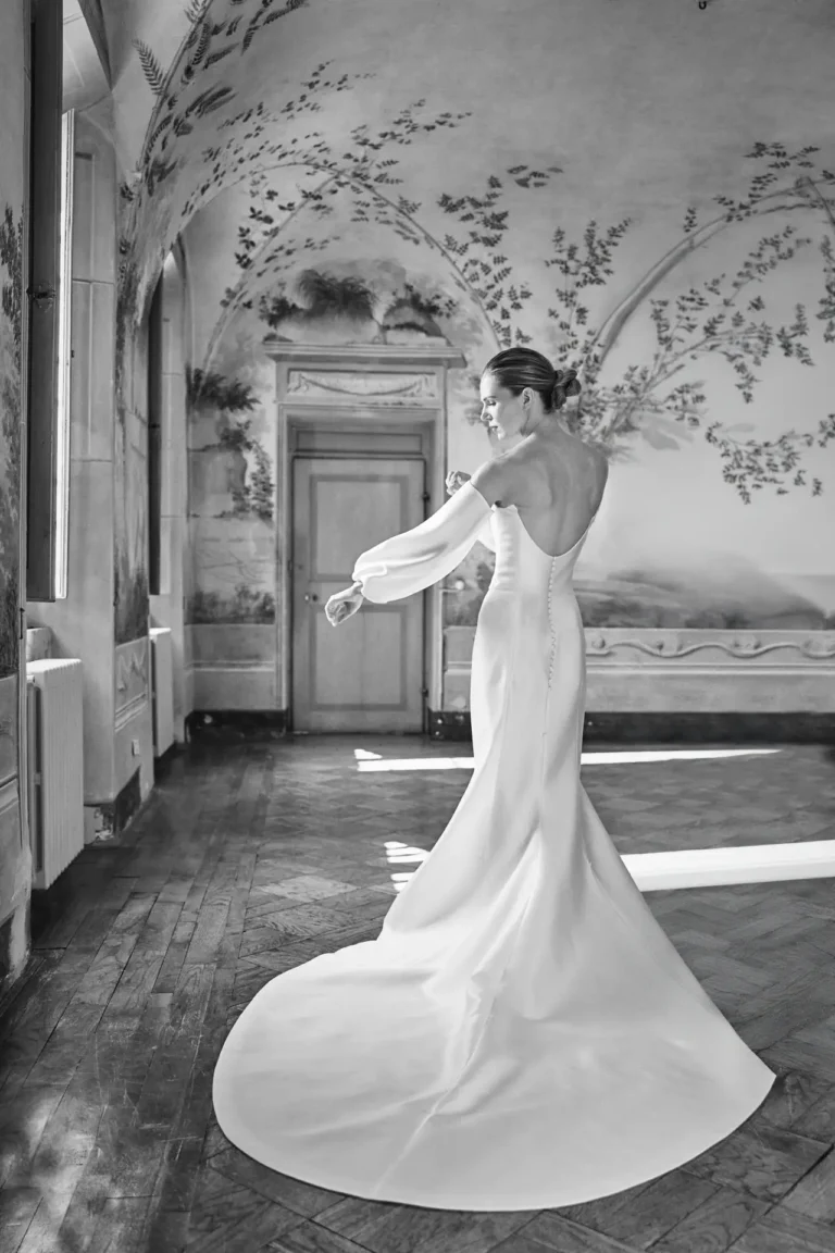 the extraordinaire stunning bride adjusting wedding dress sleeve