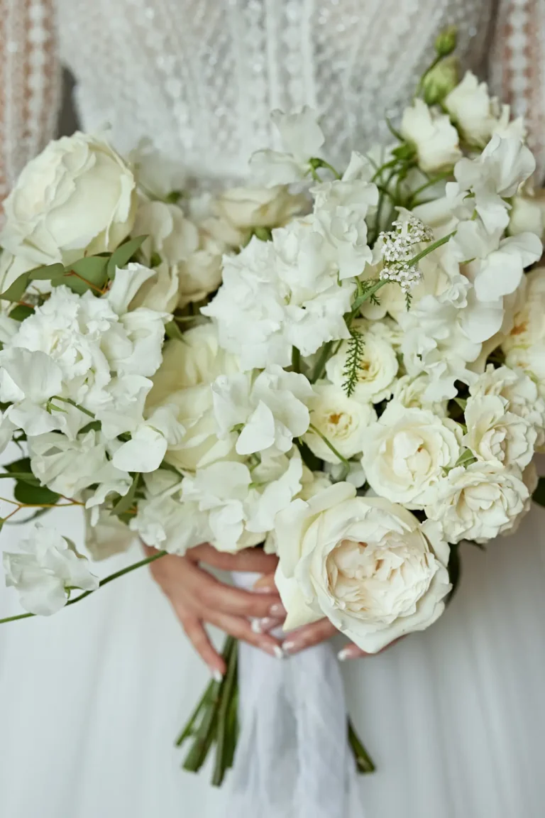 the extraordinaire umbria bride holding stunning white bouquet