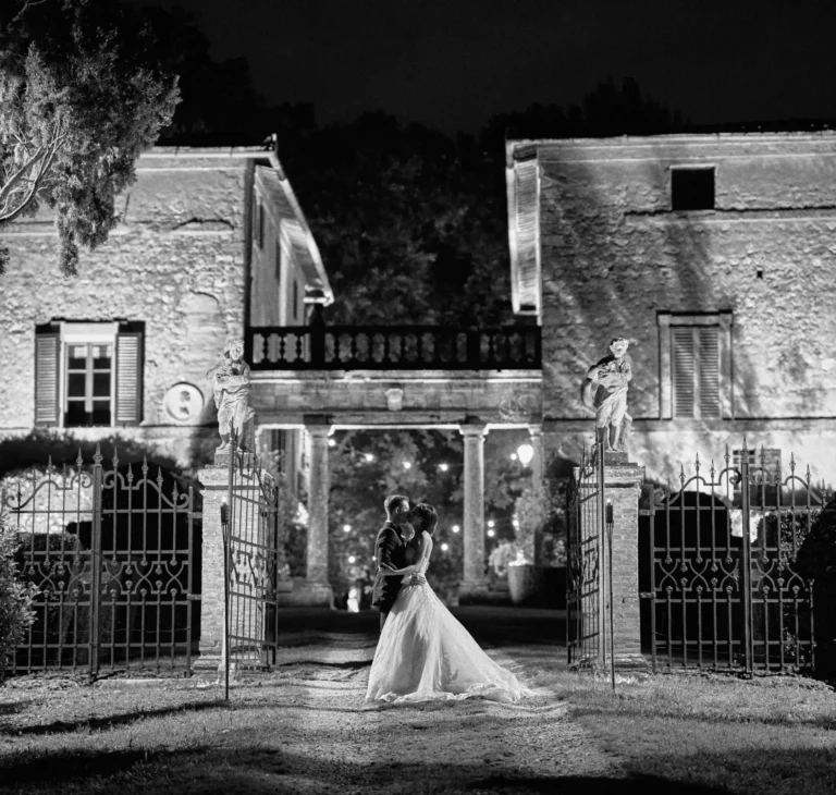 the extraordinaire borgo stomennano black and white photo couple kissing at gates