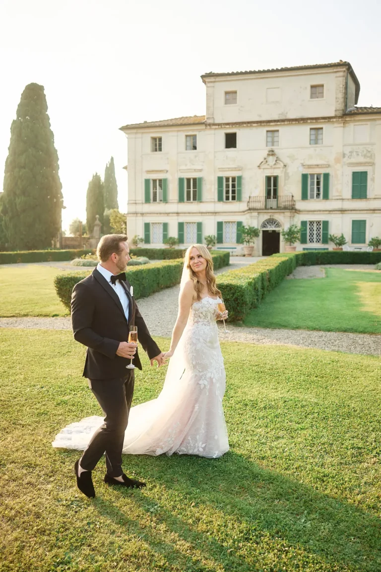 the extraordinaire tuscany villa di geggiano married couple walking in front of villa