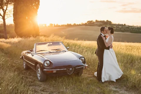 the extraordinaire umbria couple with vintage car at sunset