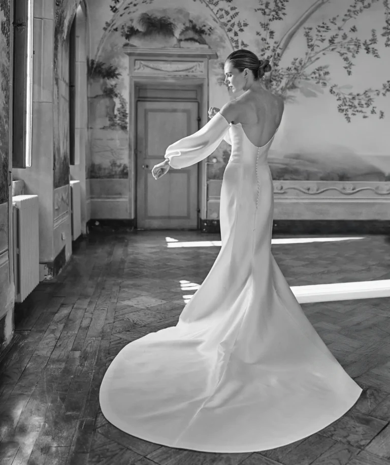 the extraordinaire bride adjusts sleeve in frescoed villa